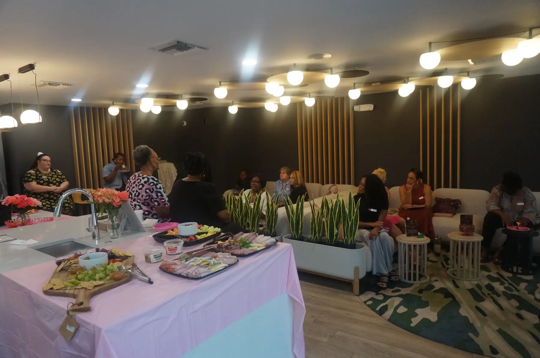 Women gathered around the charcuterie table