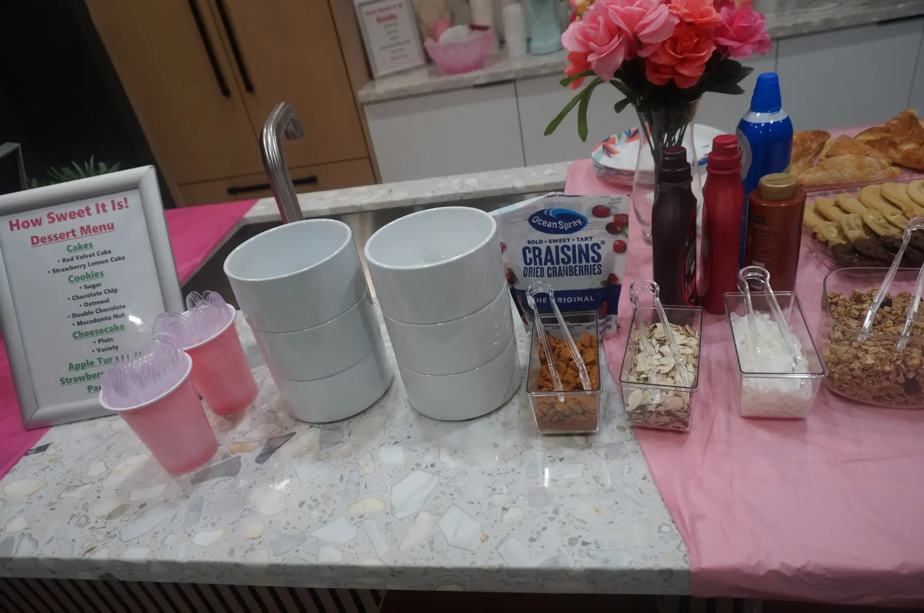 Mugs and dessert toppings arranged beside the sweets