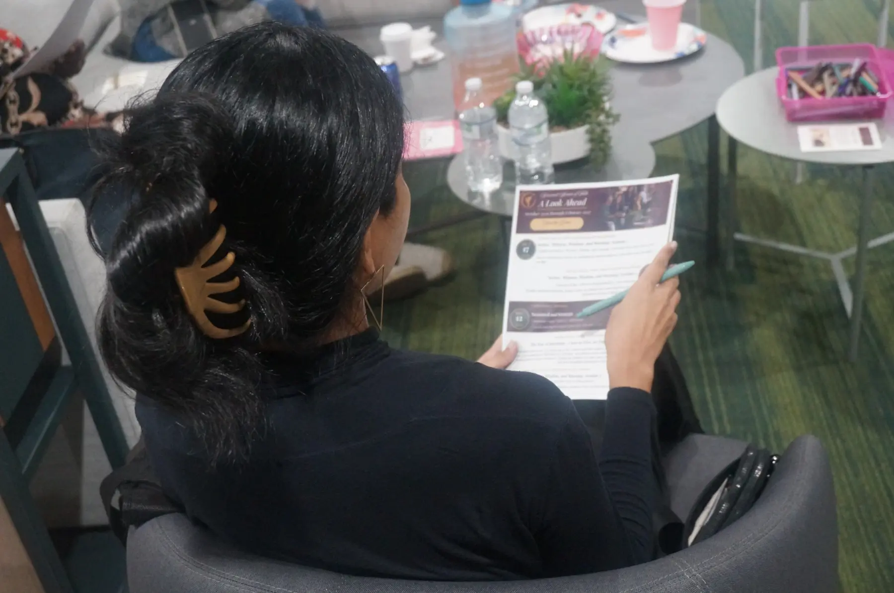 A woman seated with a reflection card during the closing conversation