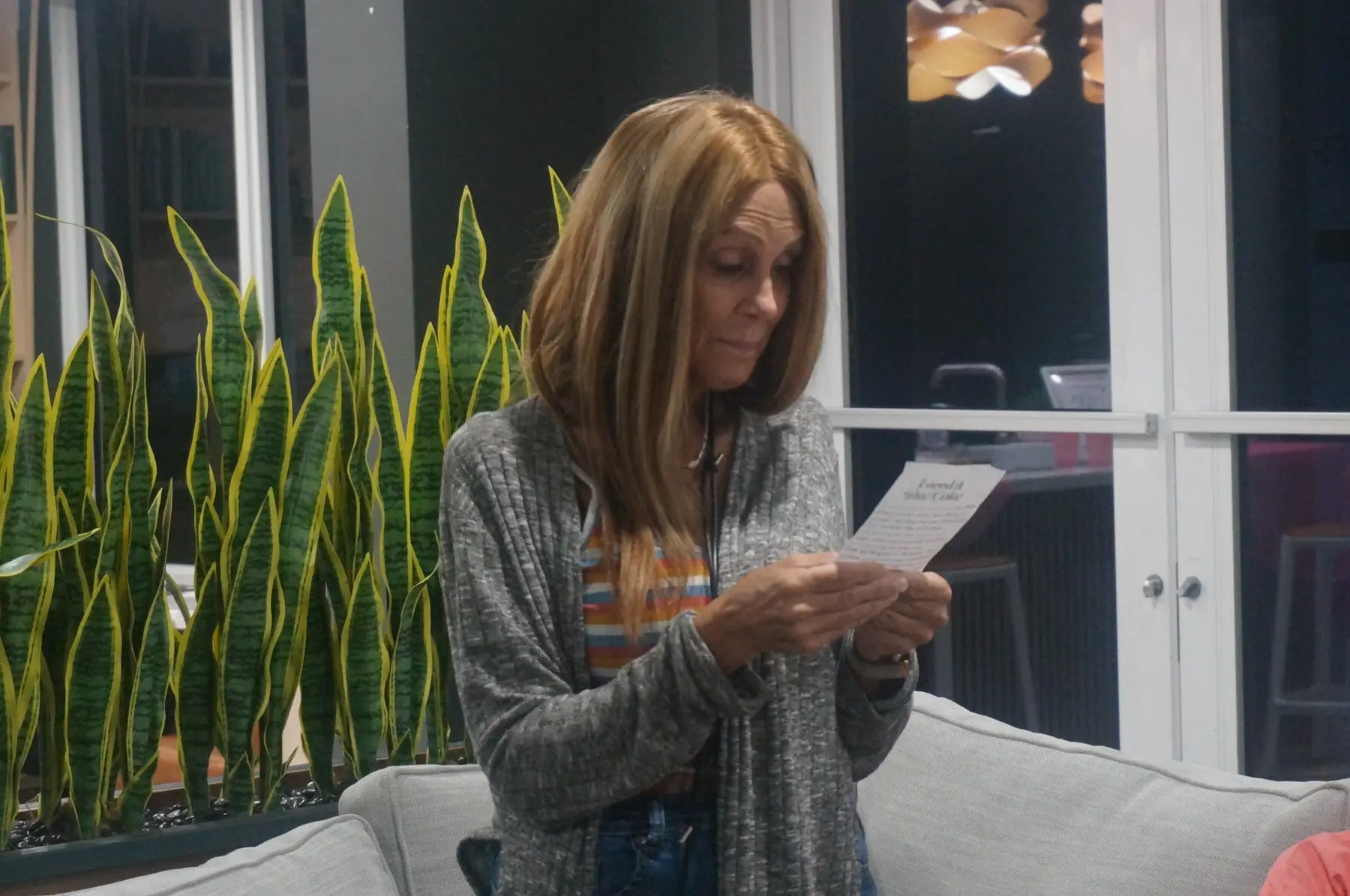 A woman reading from her response card