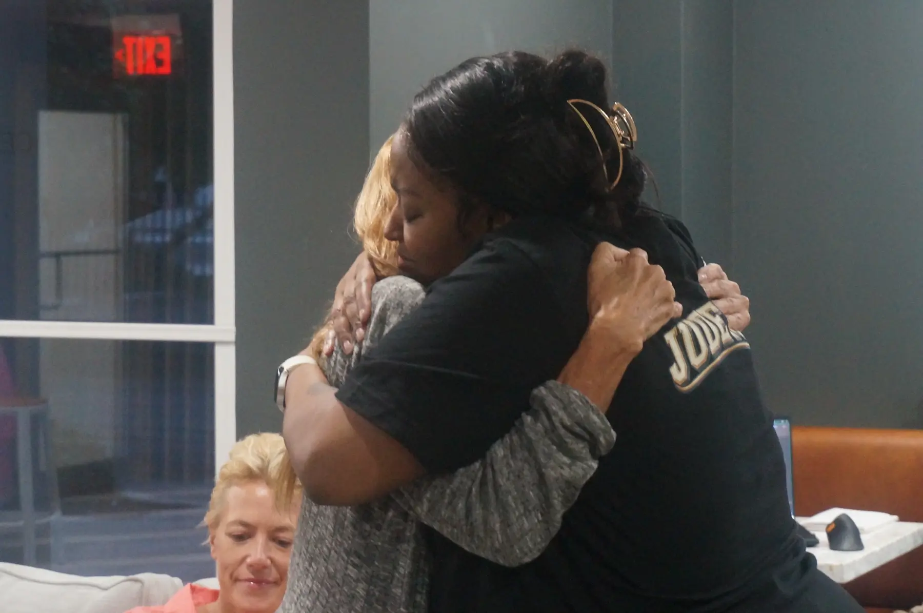 Two women embracing after a heartfelt exchange
