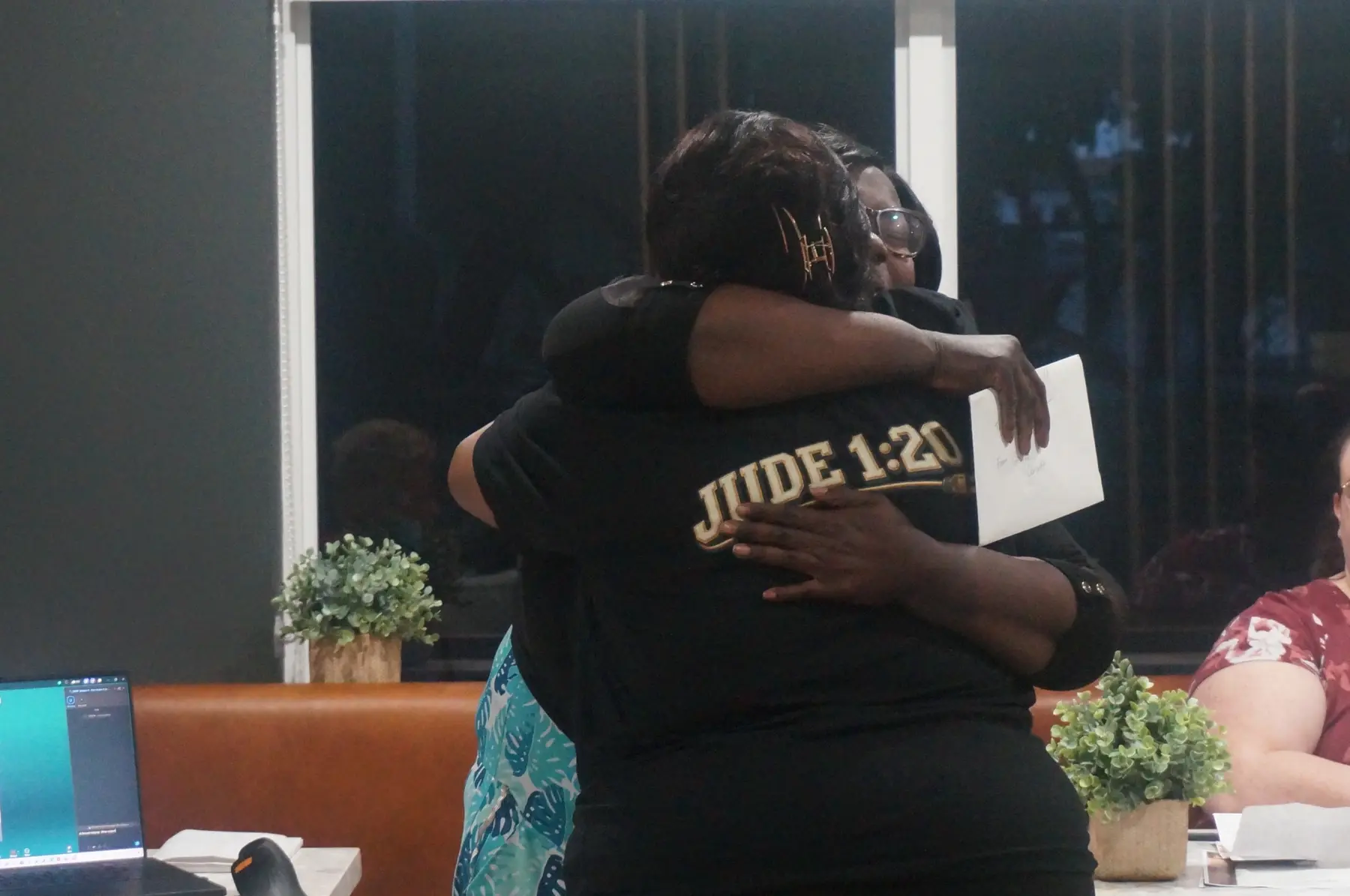 Two women embracing during the closing acknowledgments