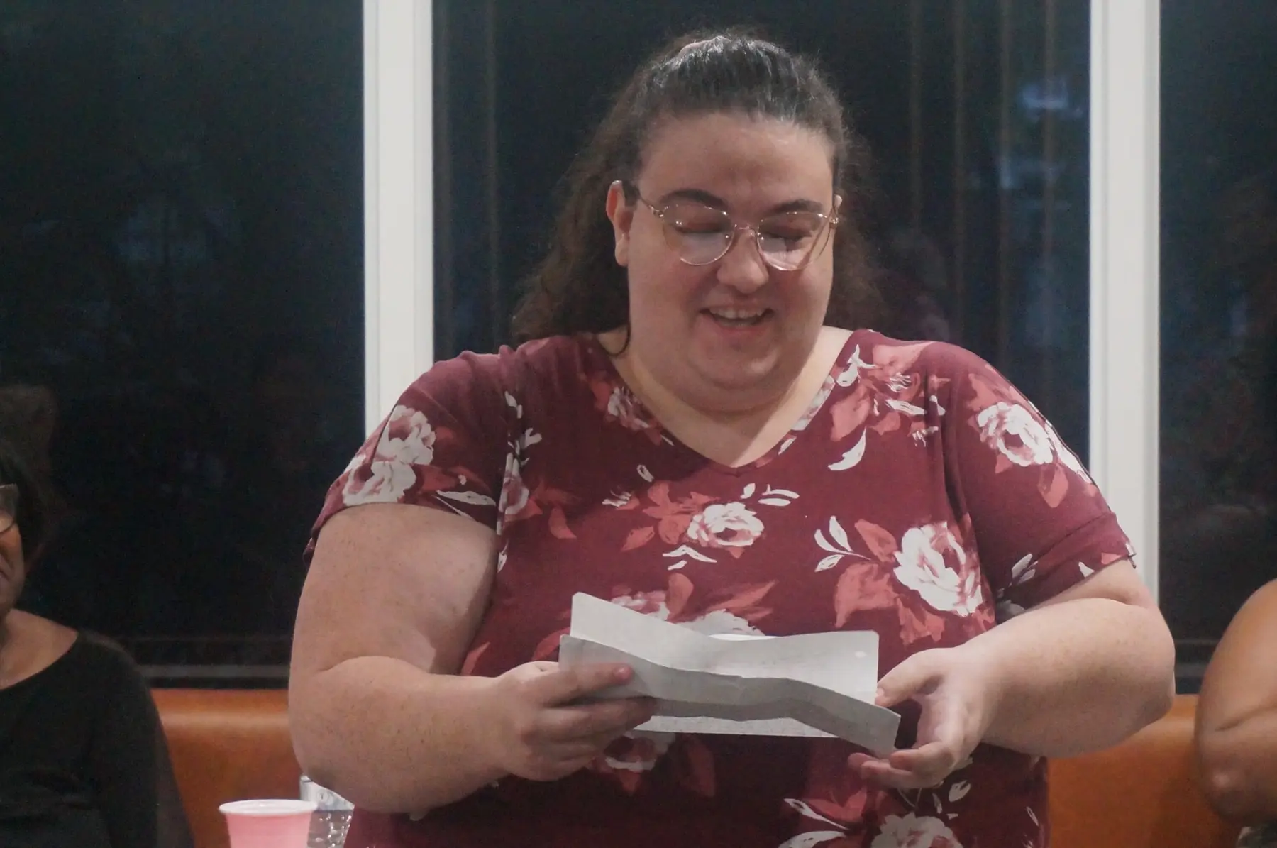 A woman reading a heartfelt message to the group
