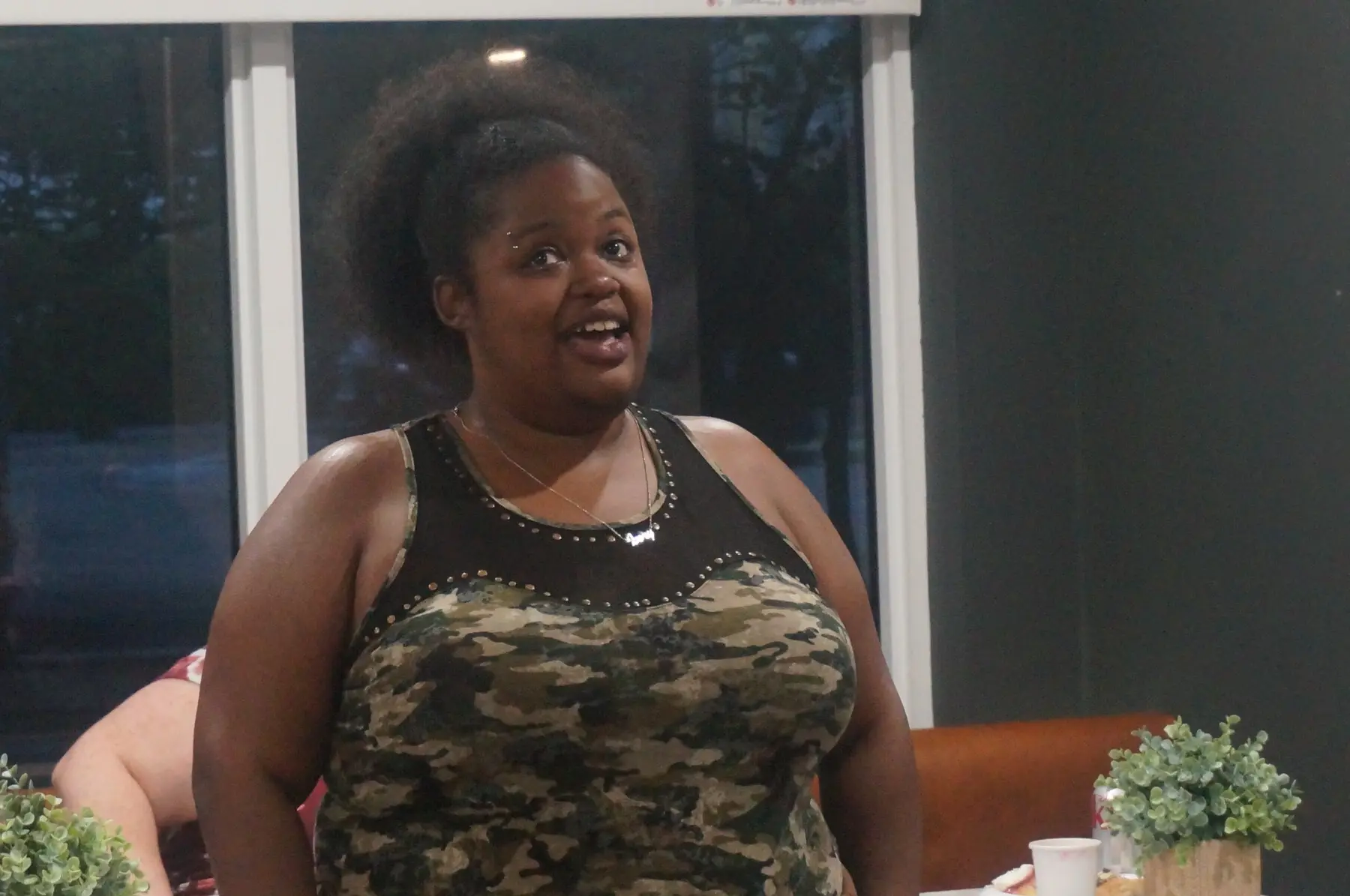 A woman standing and speaking during the closing session