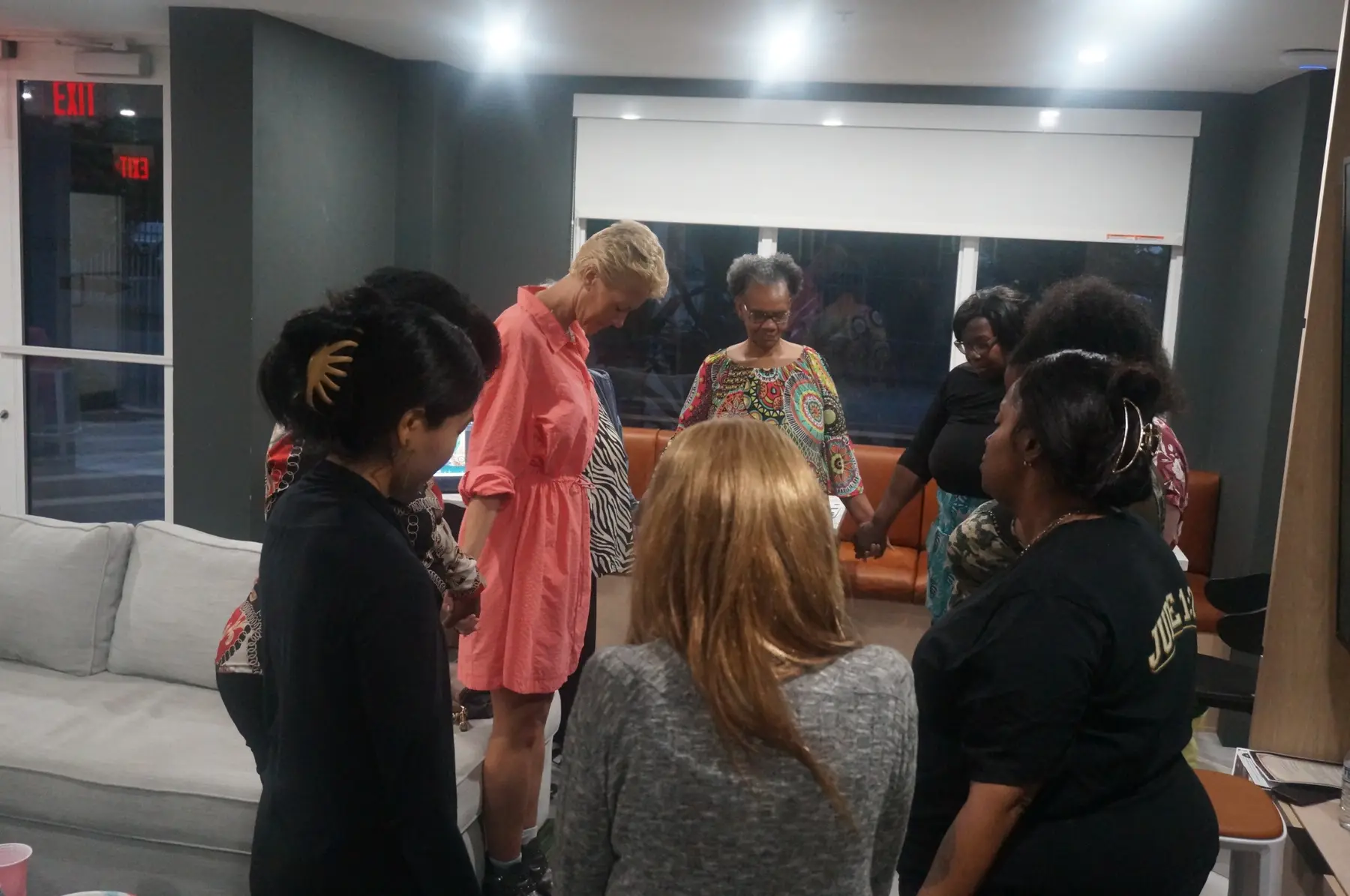 Women standing together in a circle for prayer