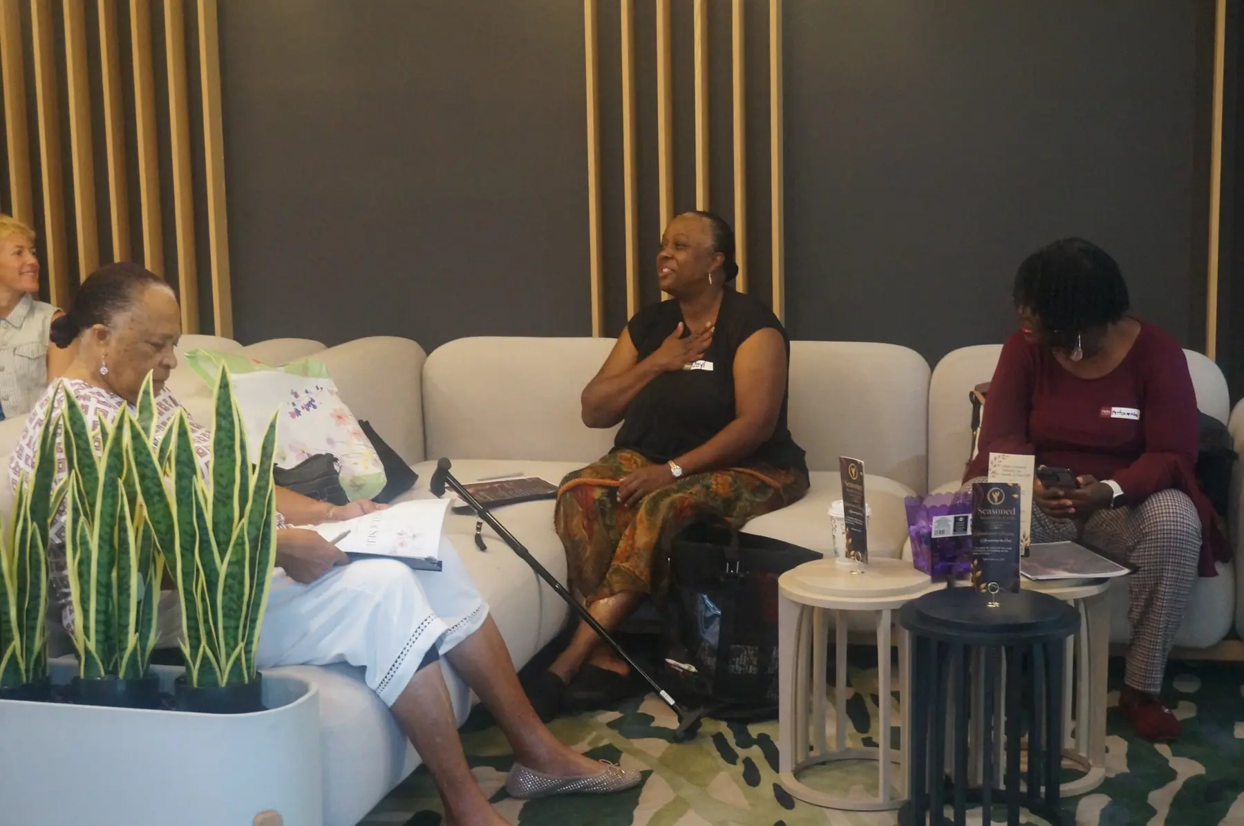 A woman sharing her testimony as other women listen
