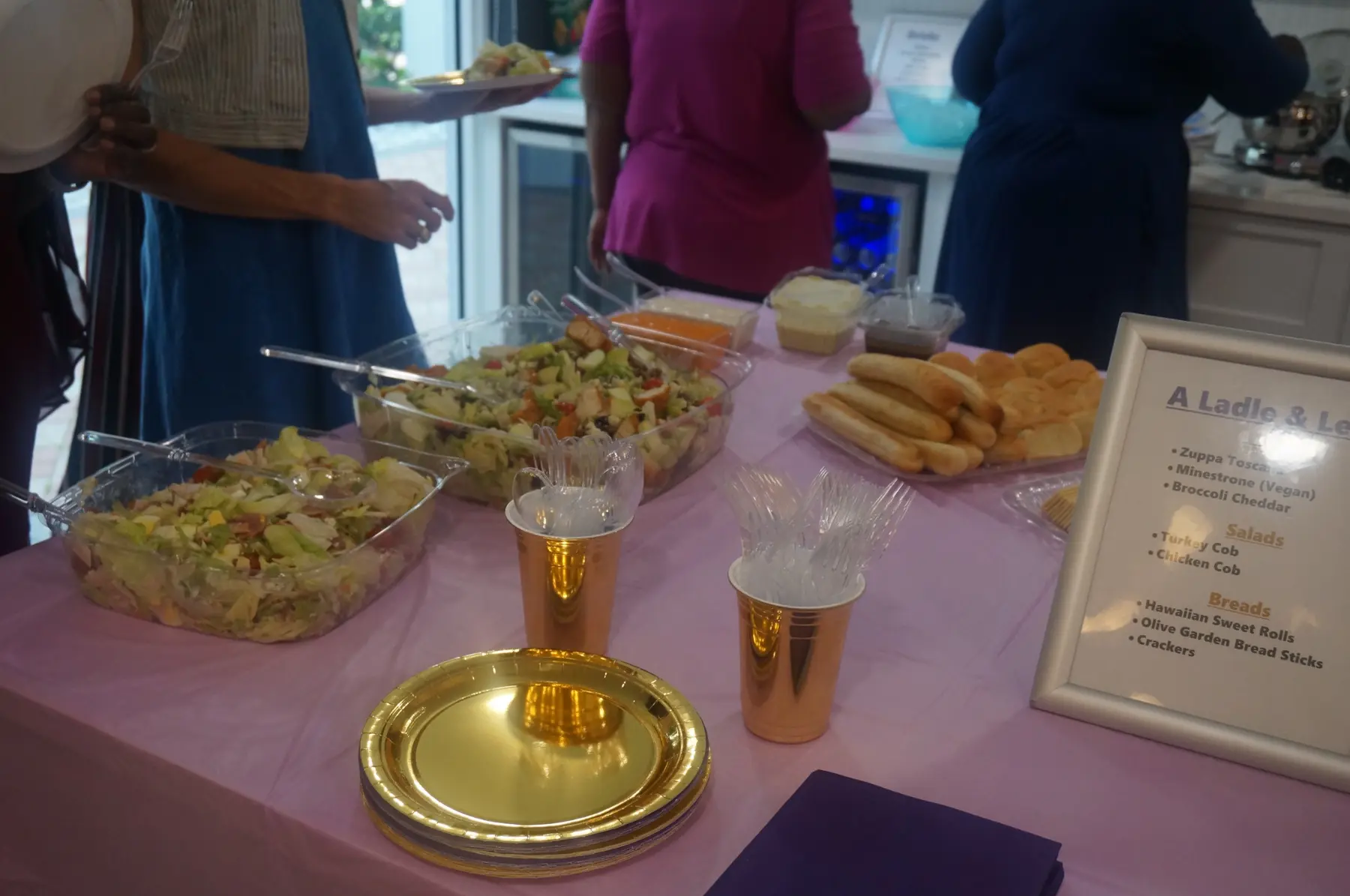 Salads, bread, serving pieces, and gold plates