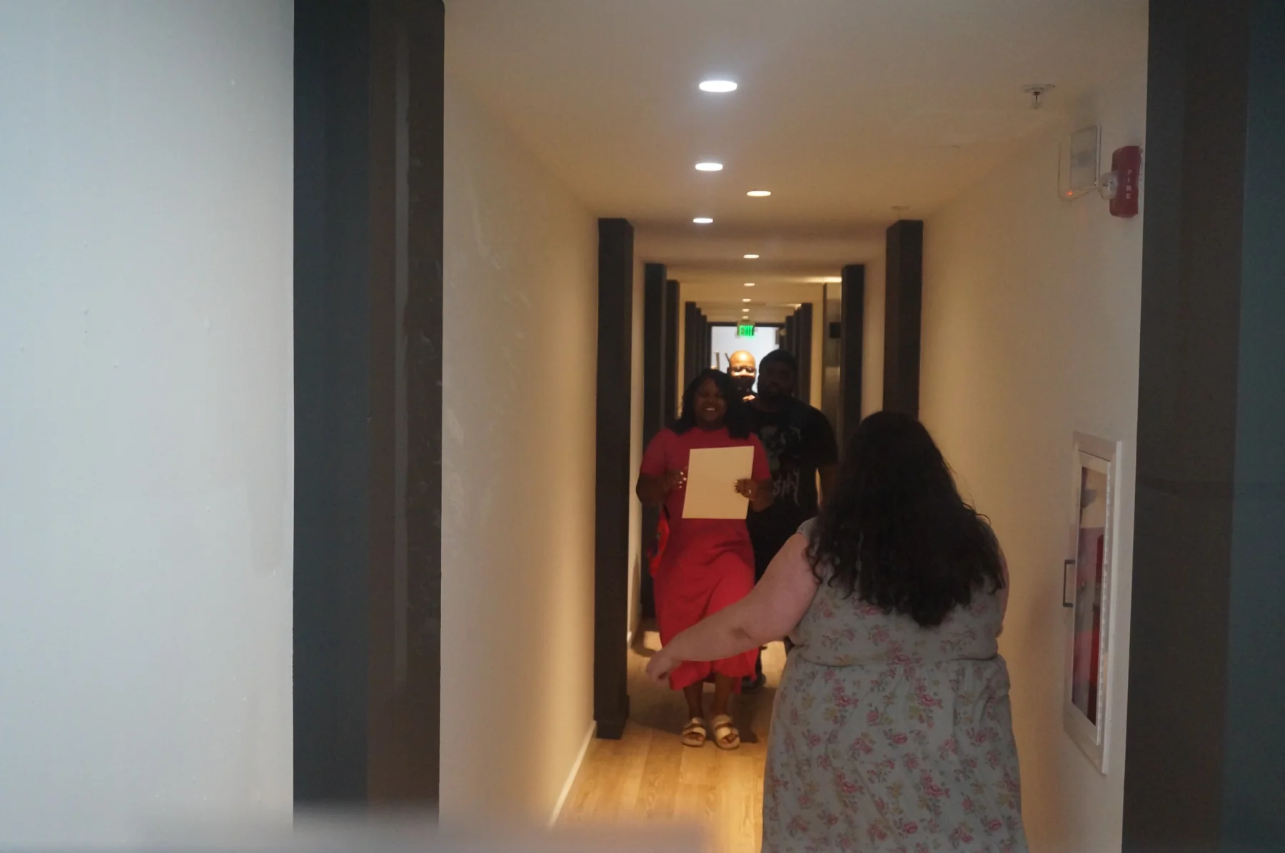 Women arriving in the hallway for the gathering