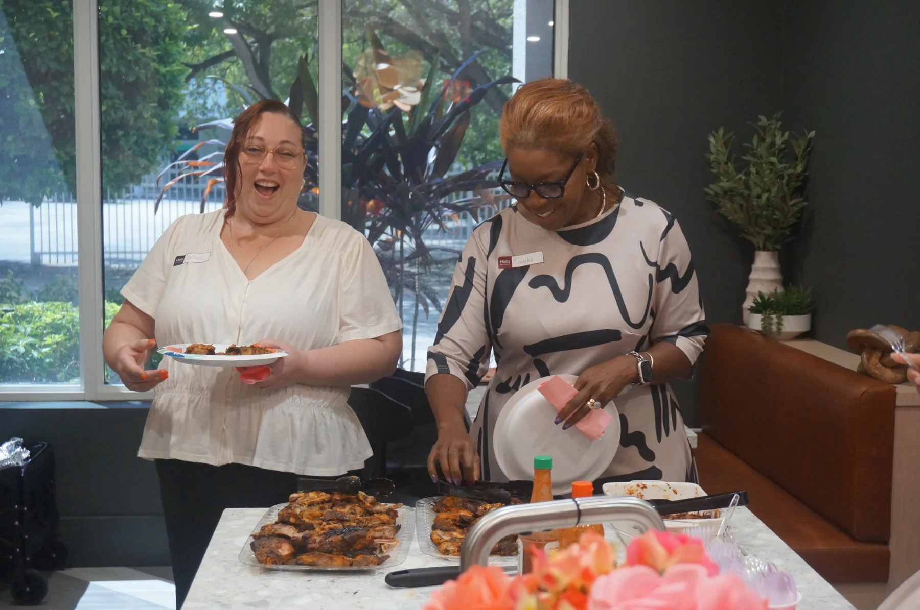 Two women smiling while selecting their dinner