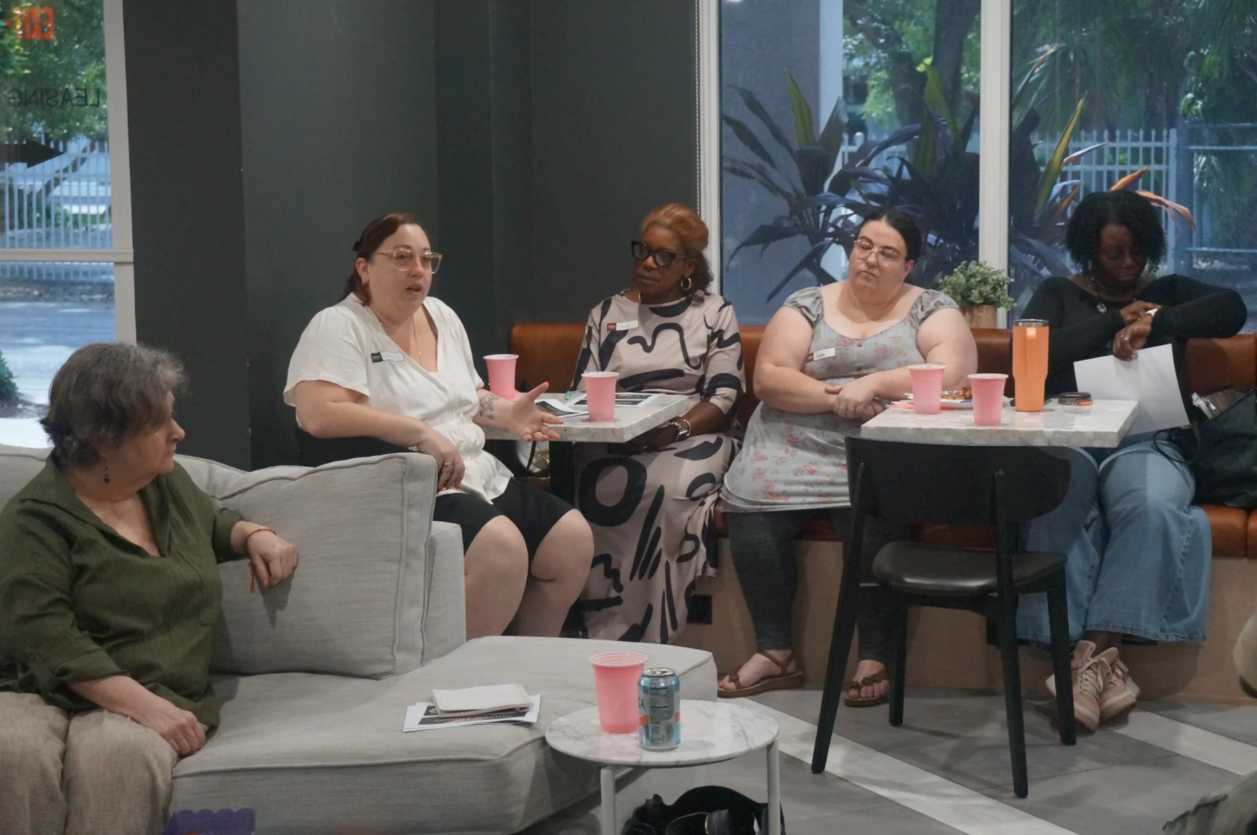 Women seated with their meals during the gathering