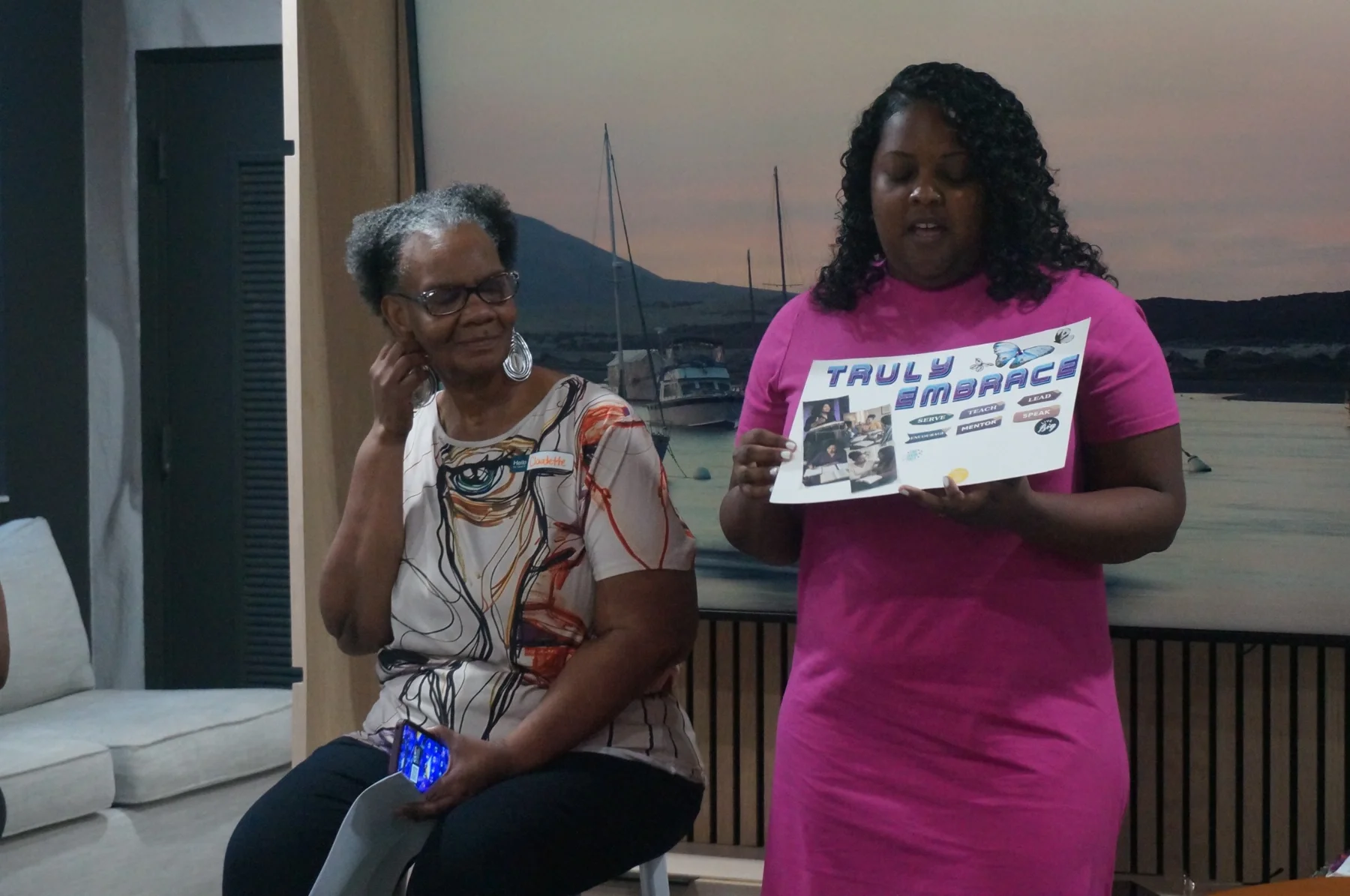A woman in pink presenting her mini-vision board