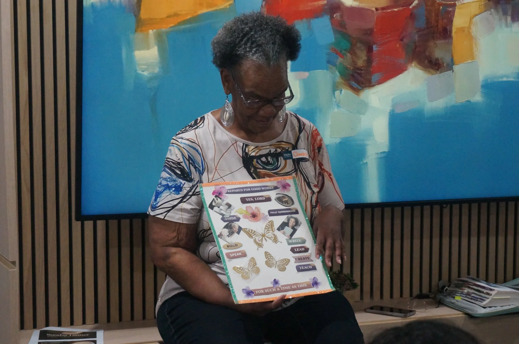 A woman looking down at her mini-vision board