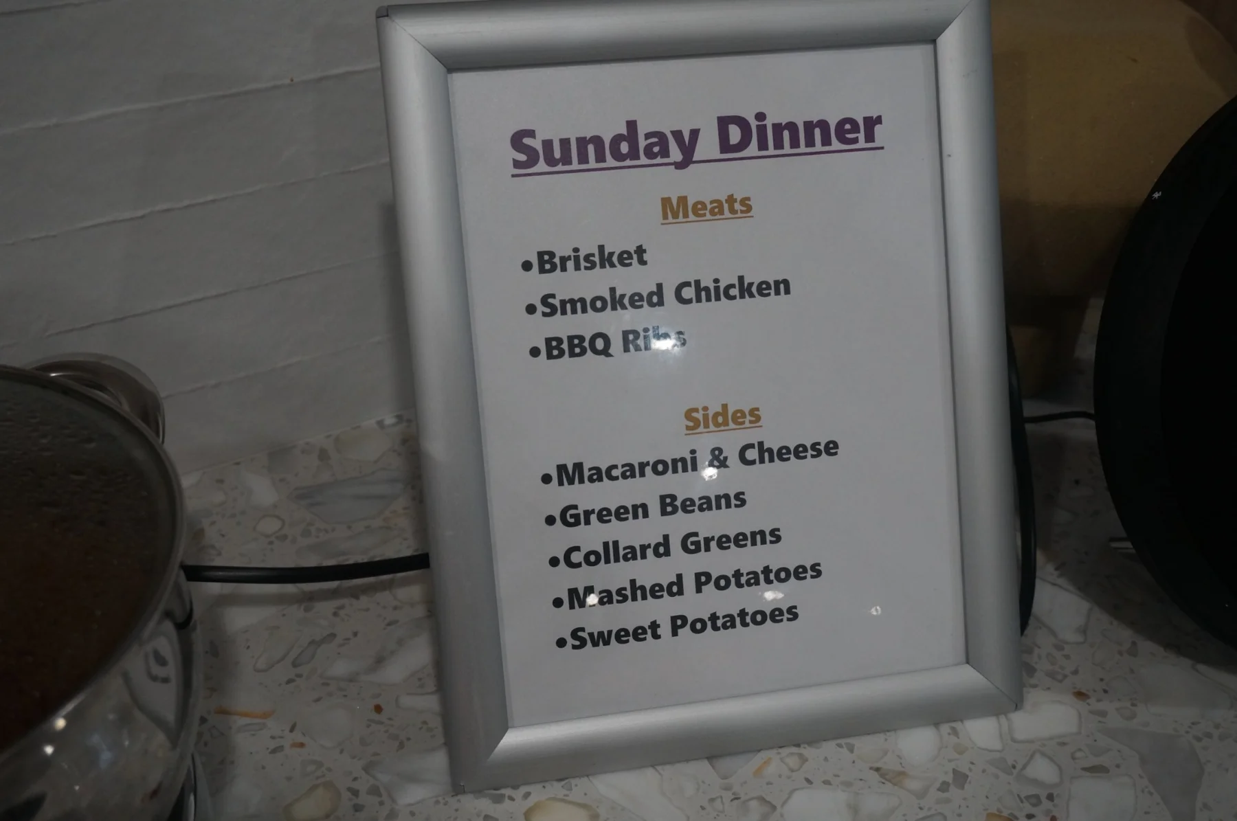 Framed Sunday Dinner menu listing the meal selections