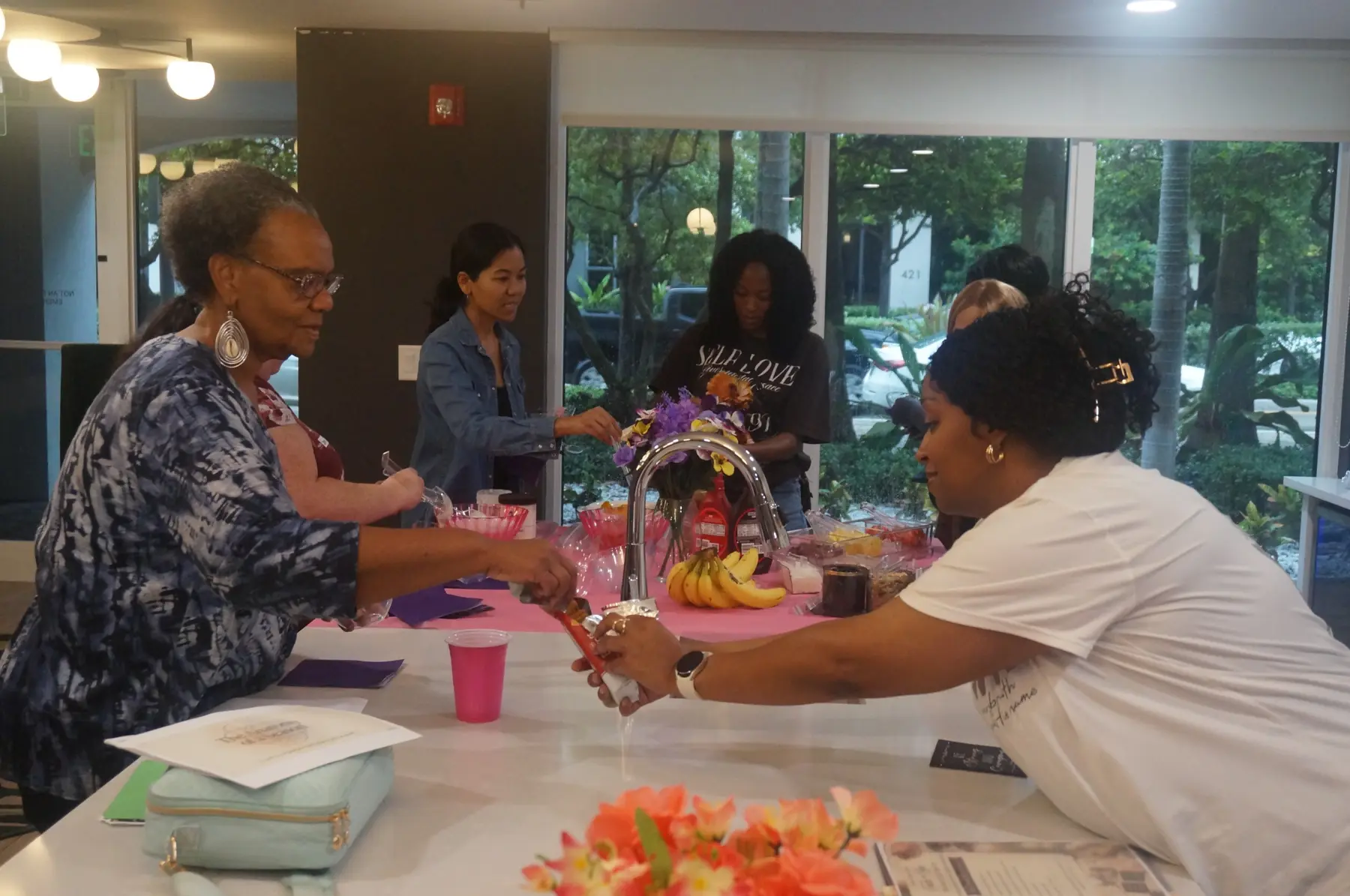 Women selecting fruit and toppings at the sorbet bar
