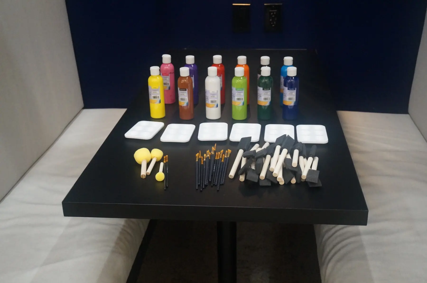 Paint, brushes, palettes, and creative tools arranged for the vision boards