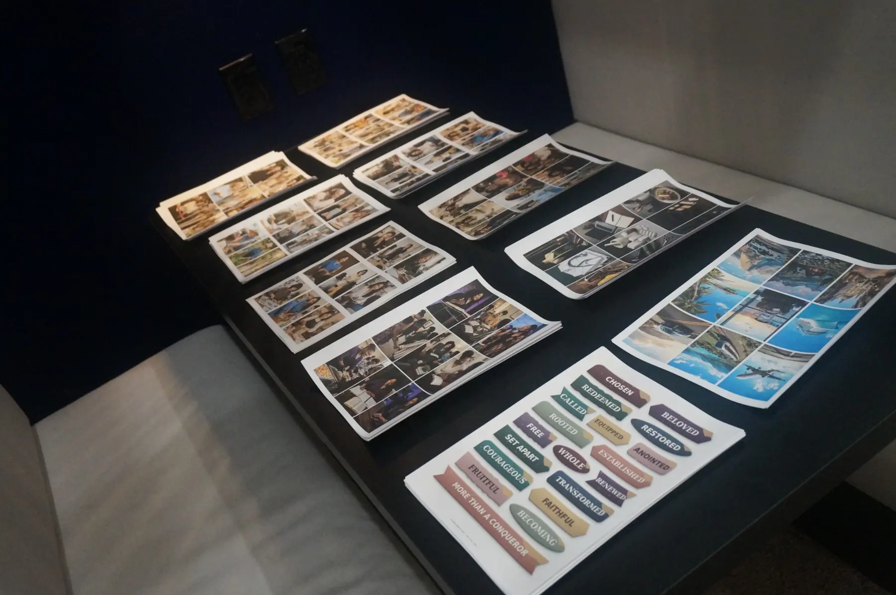 Printed photographs and milestone images arranged on a table