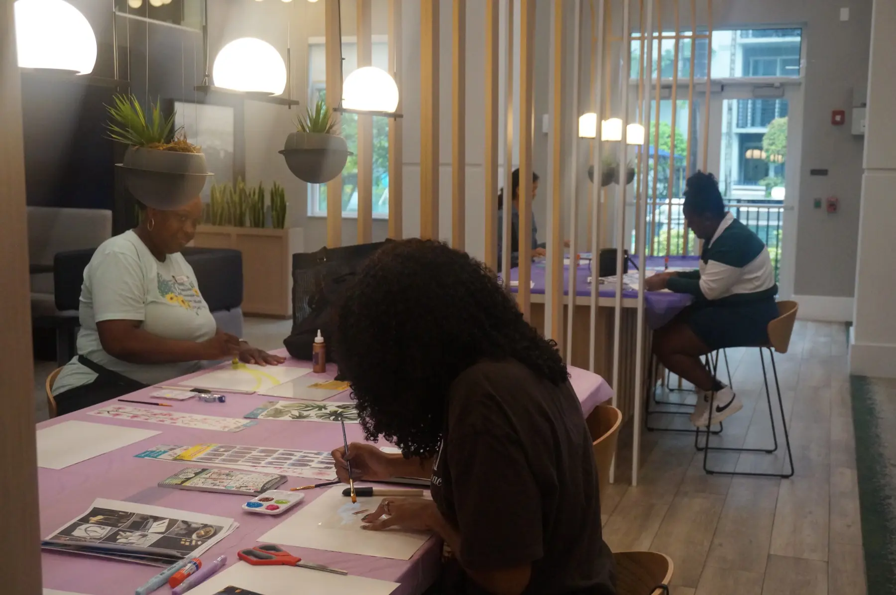 Women selecting materials and arranging their vision boards