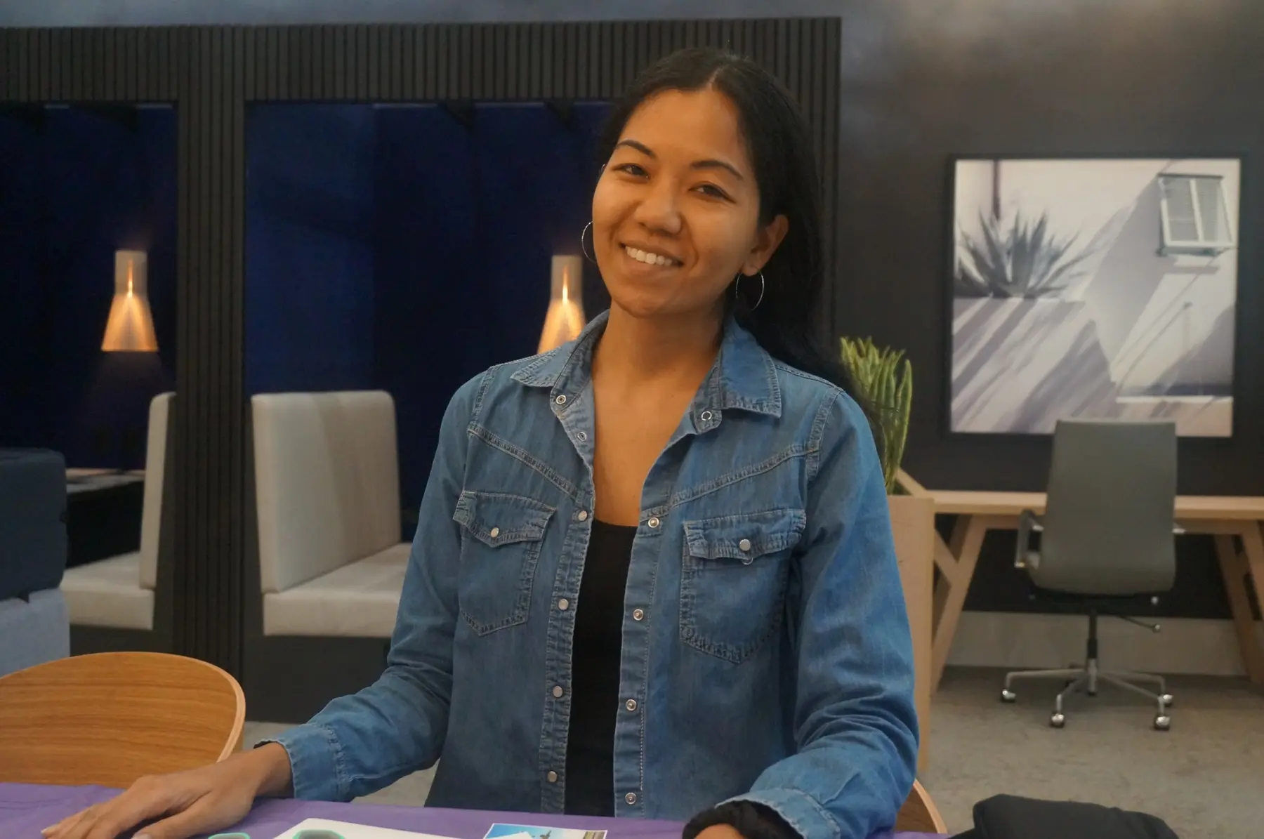 A woman seated at the vision-board table