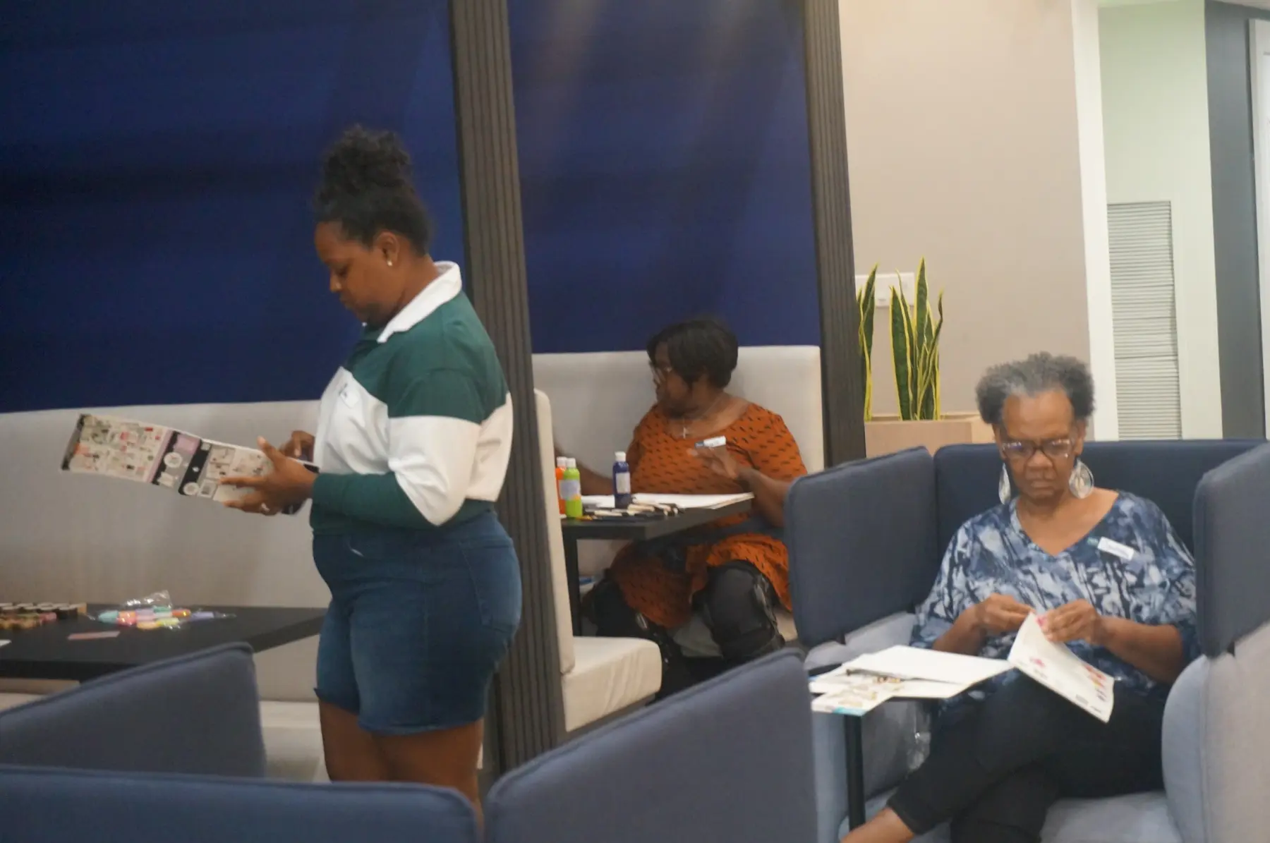 Women choosing printed images and arranging their boards